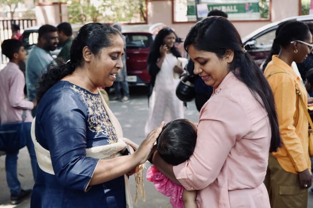 A toddler with mother outside church.