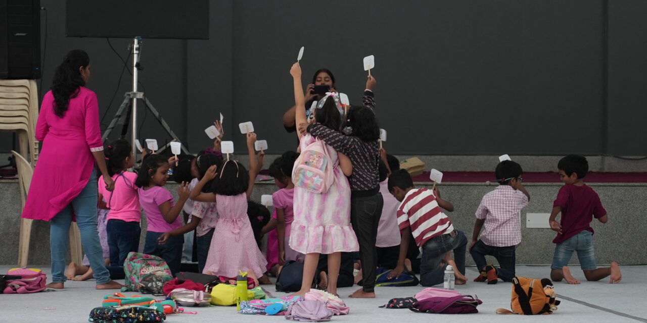 Children holding a paper in their hands and participating in fun activities